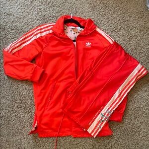 Adidas Red Track Jacket with Classic Three-Stripe Design
